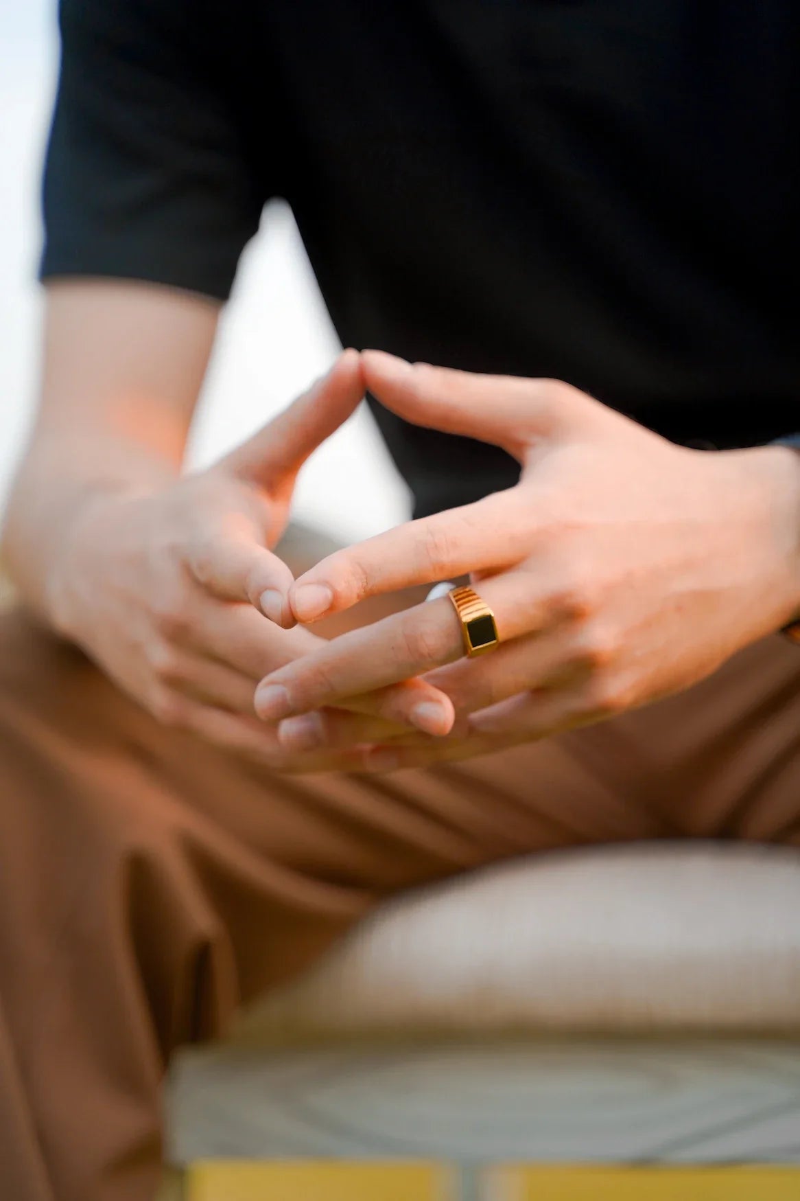 A man displaying the Valen ring, featuring its intricate design and polished black stone for a stylish appearance and styling it in daily life