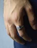 Male model wearing the Angelic Ring, highlighting the engraved angel detail and how the ring complements a modern outfit.
