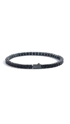 A black tennis bracelet featuring a continuous line of sparkling zircon stones, set in a sleek and polished style.
