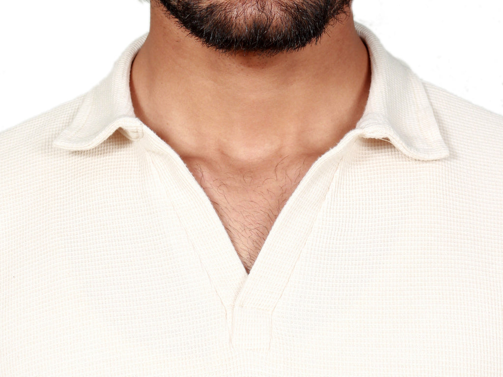 Closeup view of a beige polo shirt for men in Pakistan showing fabric detail and stitching
