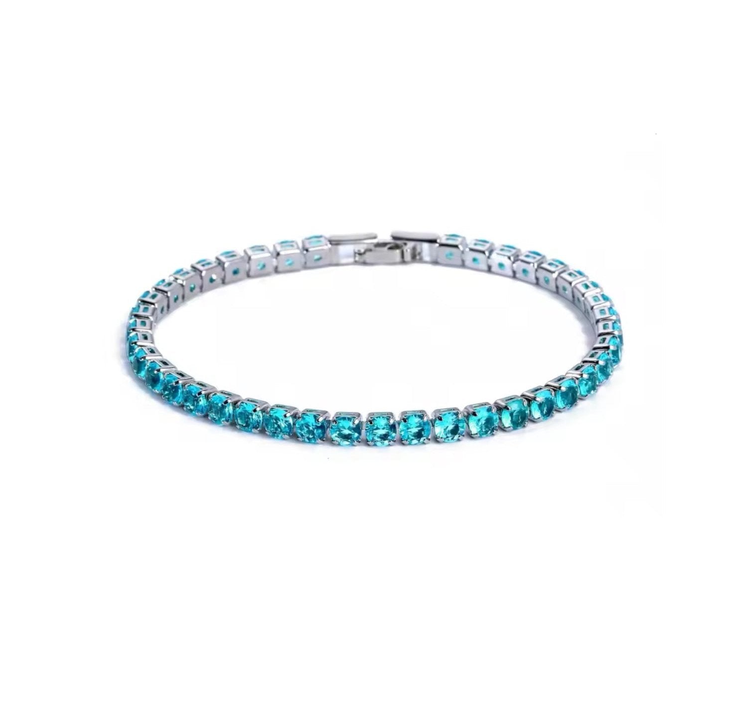 Light blue tennis bracelet displayed on a clean white background, featuring round-cut blue stones set in a polished silver frame  with a refined finish.