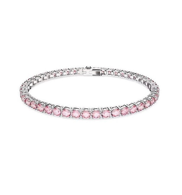 Pink tennis bracelet displayed on a white background, showcasing luminous blush stones with a sophisticated and timeless finish.